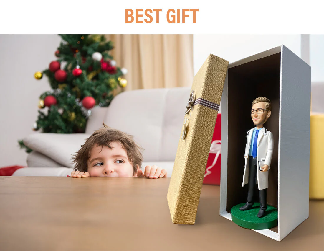 Child peeks at a present on a table; an open gift box reveals a doctor figurine inside a green base.