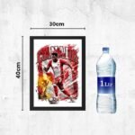 Framed Canada soccer poster showing a red-jersey player and 'CANADA' text, sized 40 cm by 30 cm, beside a 1 L water bottle for scale.