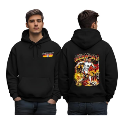 Black hoodie with a small Germany soccer logo on the chest and a front pocket. On the back, a colorful poster-style scene features a soccer player and the word 'GERMANY' above.