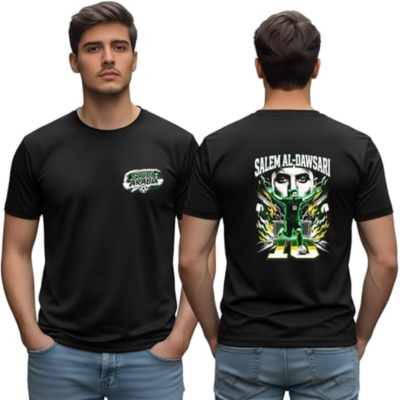 Black t-shirt model with a small Saudi Arabia crest on the front and a bold 'Salem Al-Dawsari' graphic on the back showing a soccer-inspired design.